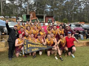 Deanmill Football Club players celebrate their 2024 LSWFL Retravision Manjimup Reserves Grand Final victory, lifting the premiership shield.