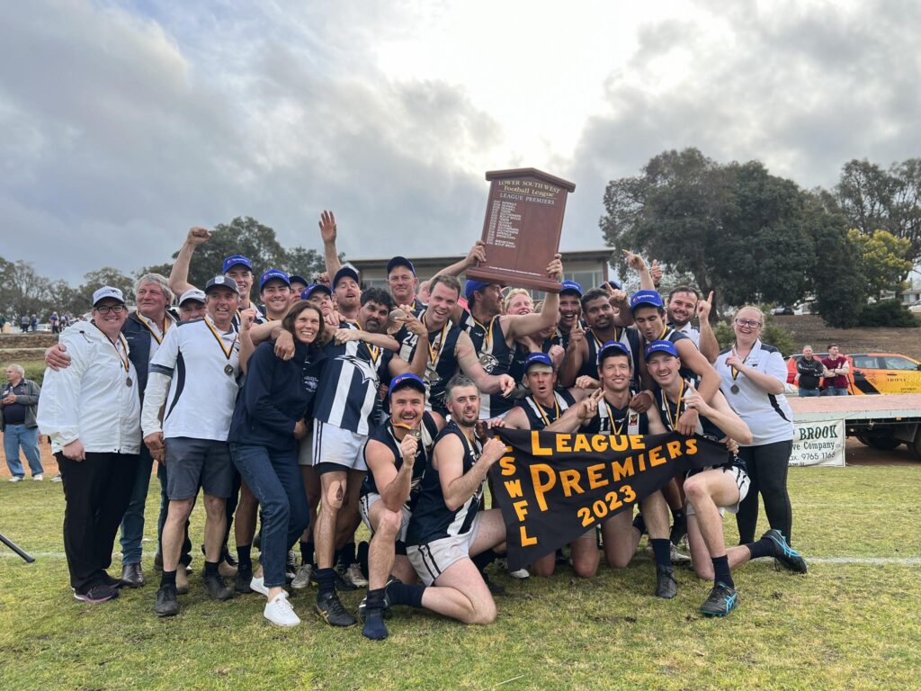 Kojonup Football Club League players celebrate their 2023 LSWFL Manjimup Tyrepower League Grand Final victory, lifting the premiership shield.